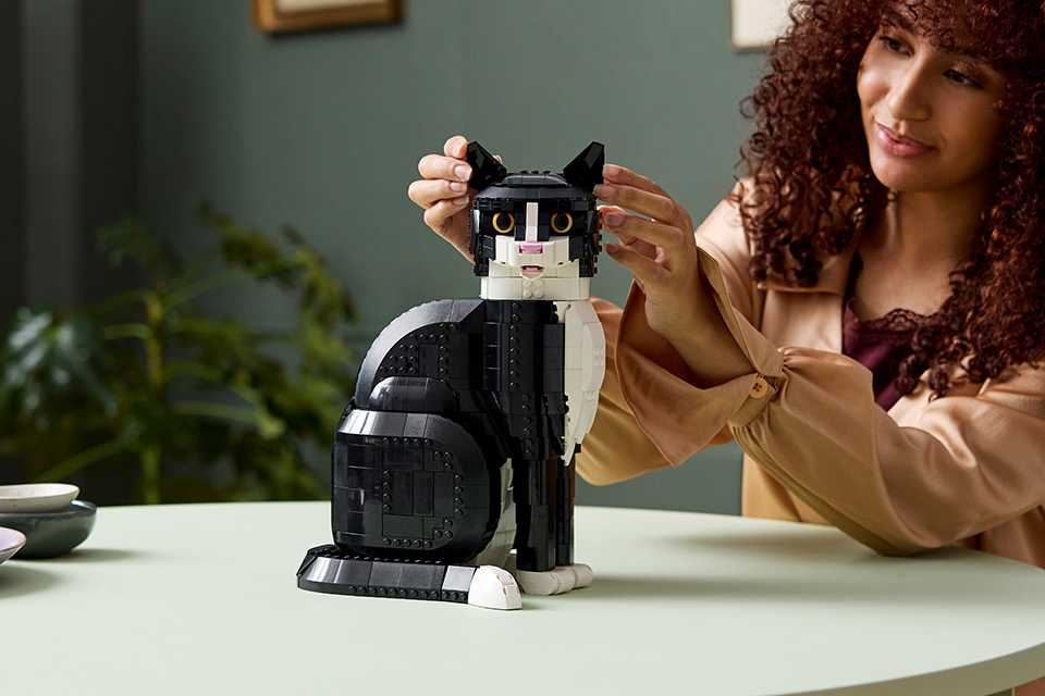 Woman modelling the black and white LEGO® tuxedo cat set.