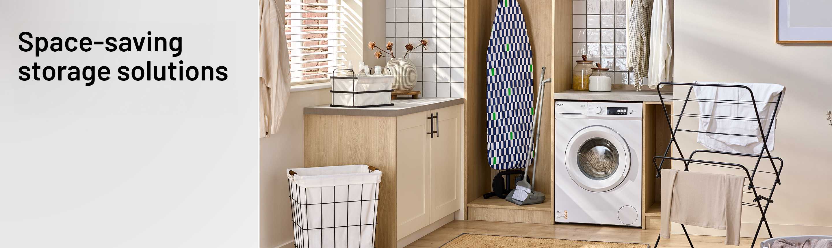 A washing machine, laundry basket, clothes airer, cabinet and an ironing board in a utility room.