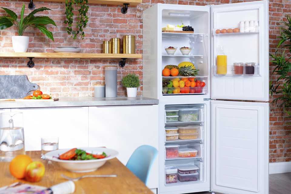 A white freestanding fridge freezer placed in a kitchen.