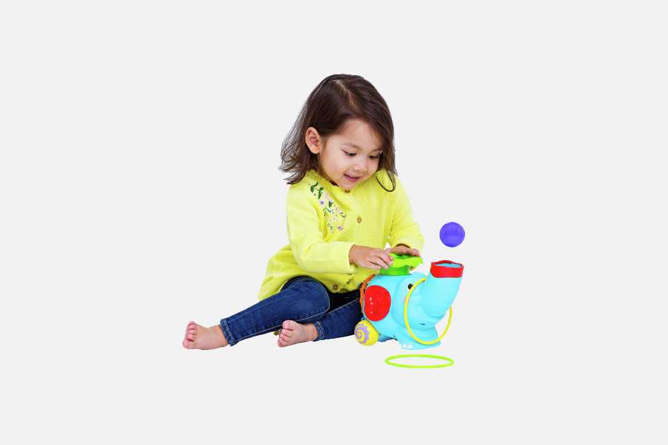 A little girl playing with a Chad Valley Ball Pop Elephant.