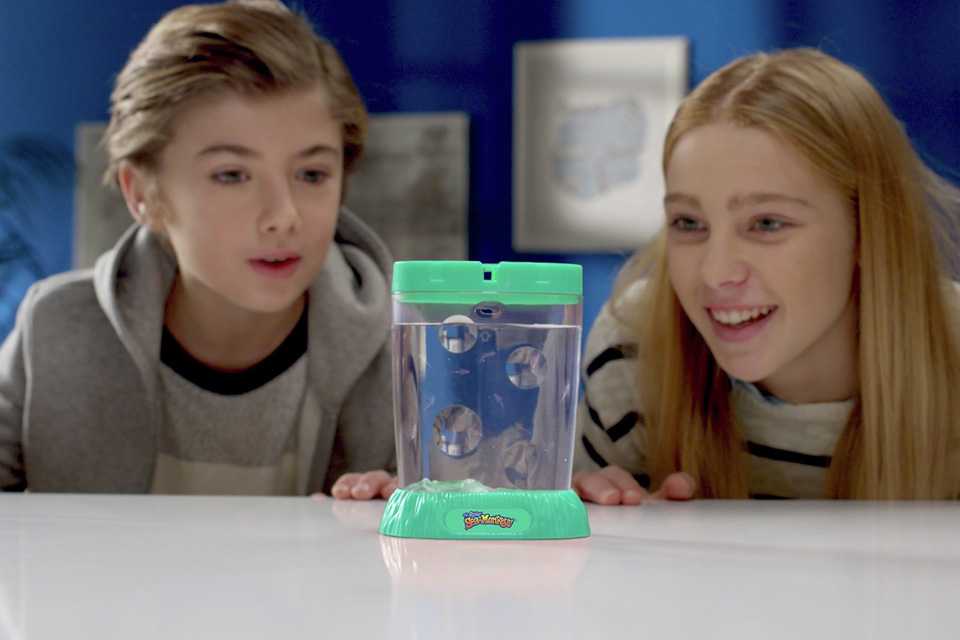 Two children playing with The Original Sea Monkeys Ocean Zoo.