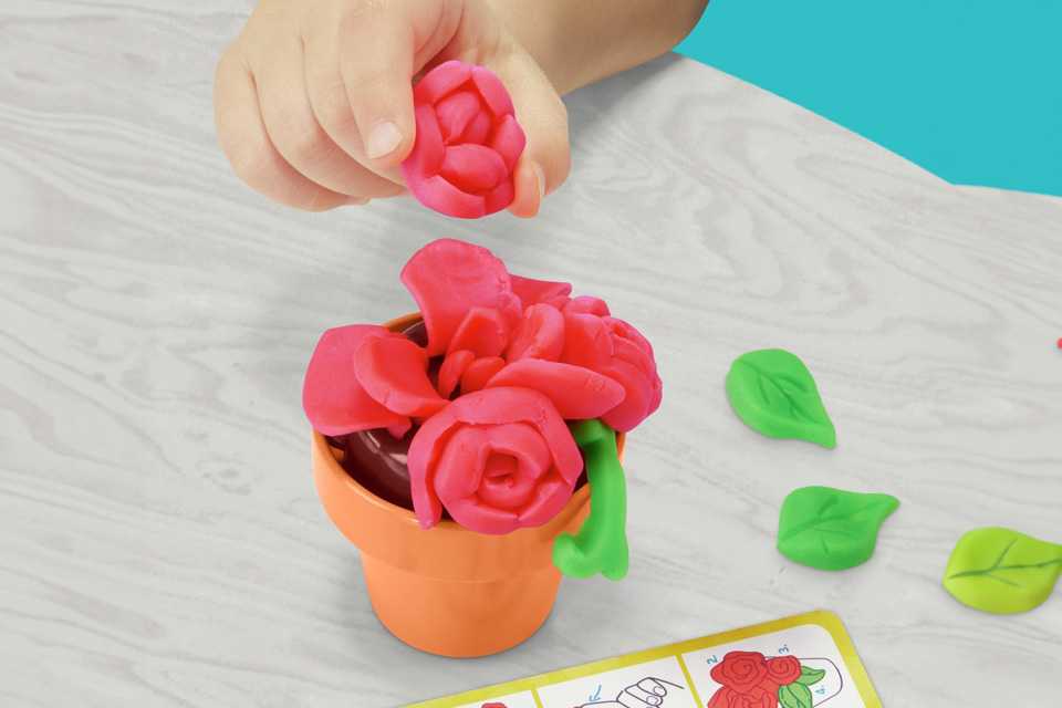 A child playing with Play-Doh Fantastical Flowers.