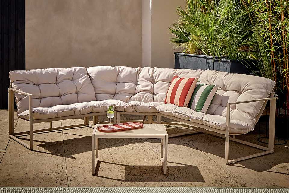 A beige Argos Home 5 seater garden sofa set on a patio.