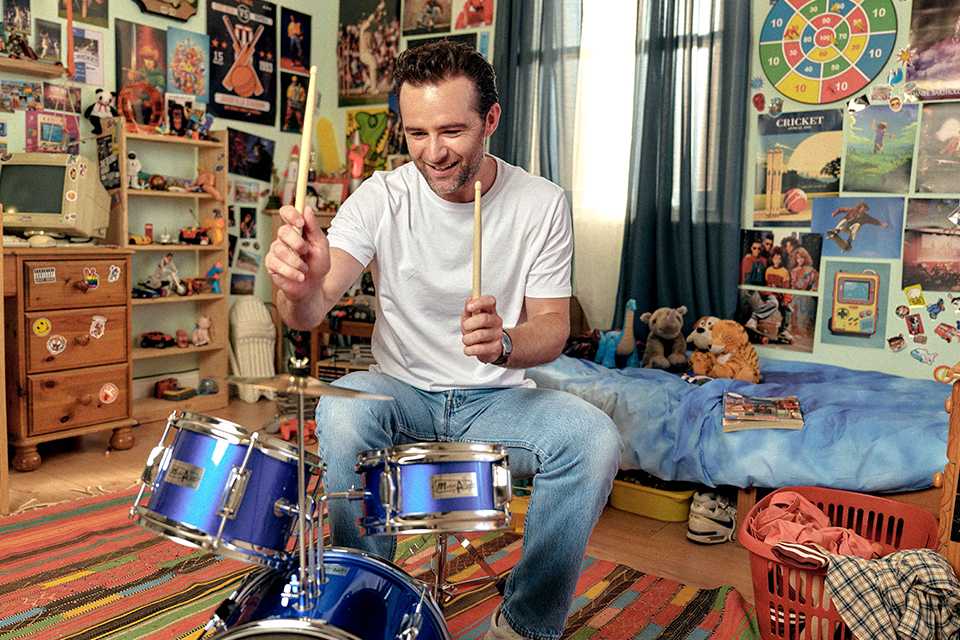McFly drummer Harry Judd listening to songs from a CD player.