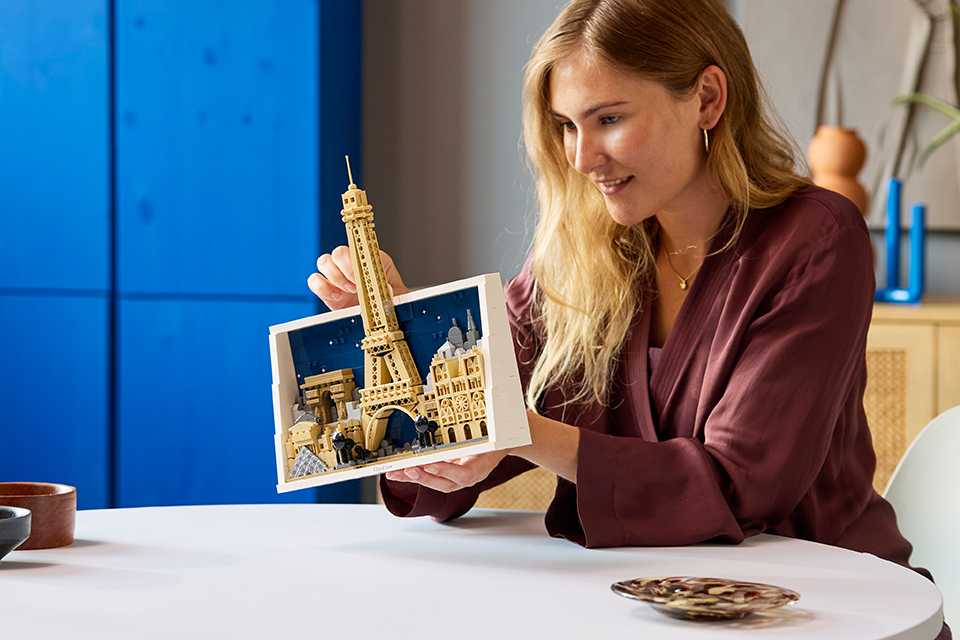 Woman holding the LEGO® Architecture Paris City of Love Building set.
