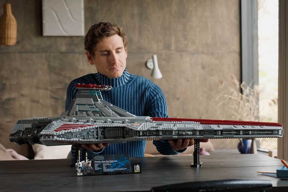 Man admiring the LEGO® Star Wars Venator-Class Republic Attack Cruiser set.