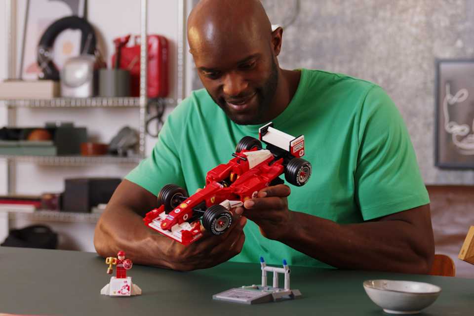 Man holding the LEGO® Icons Ferrari F2004 set.