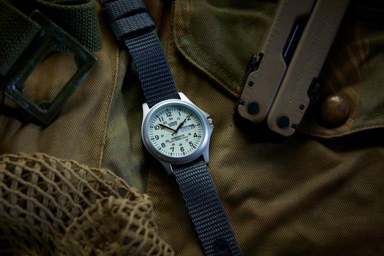 A Lorus watch is displayed on khaki fabric.
