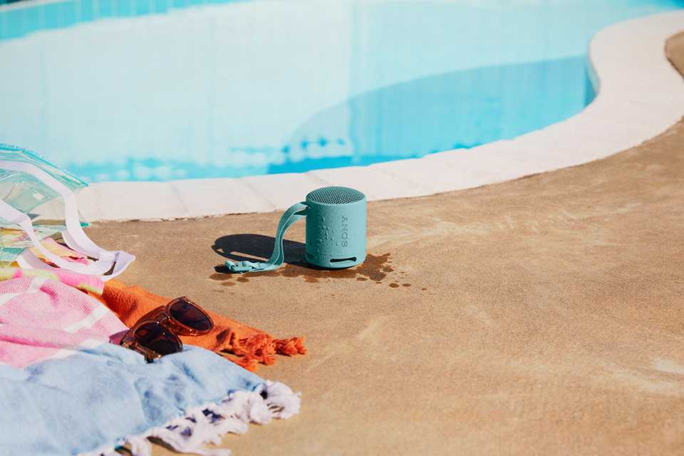 A Sony portable speaker by the pool.