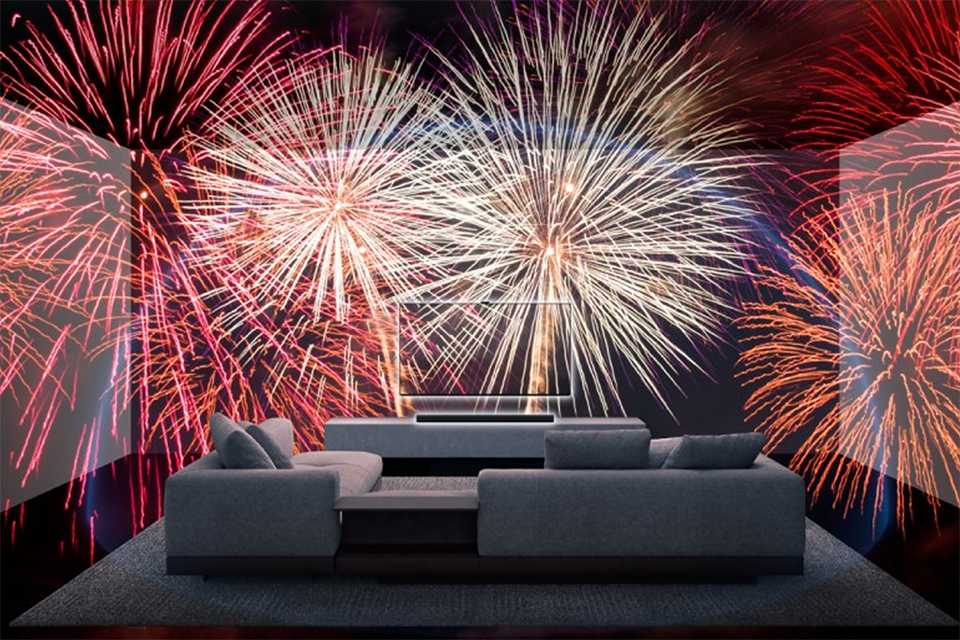 Life-like fireworks going off in front of a Sony TV.