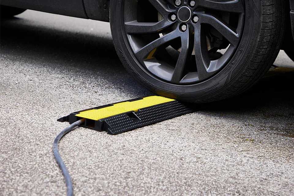 A car tire over a Ring EV cable ramp.