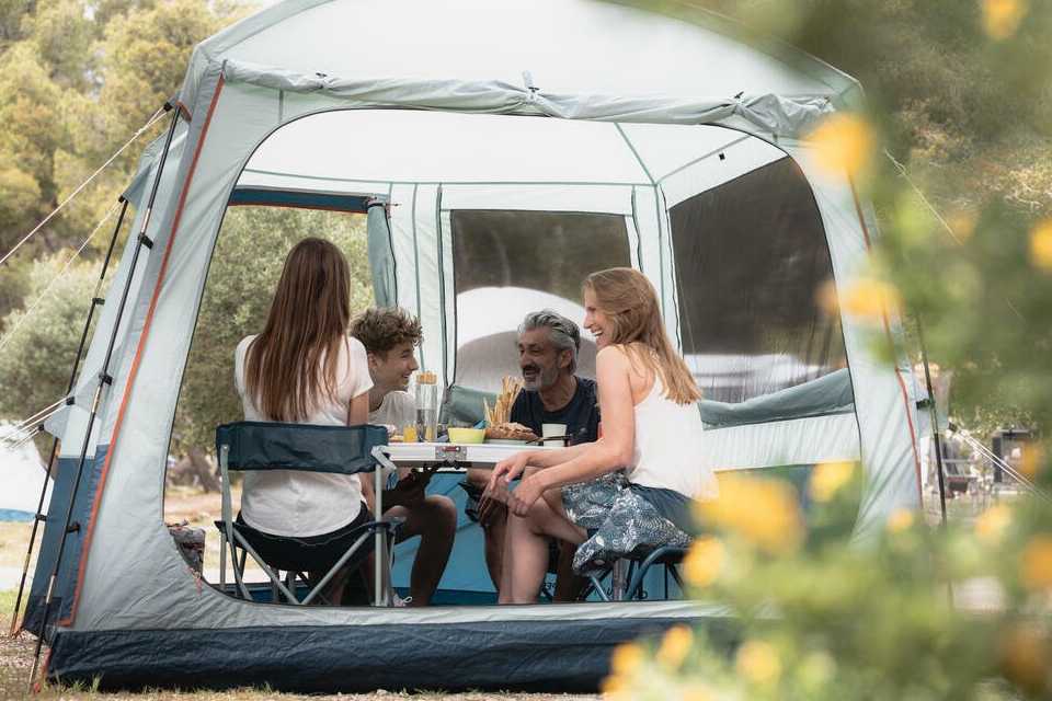 family camping in tent outside