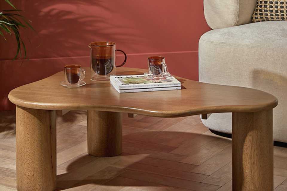 Coffee and tea cups on a Habitat Mariel Coffee Table - Walnut.