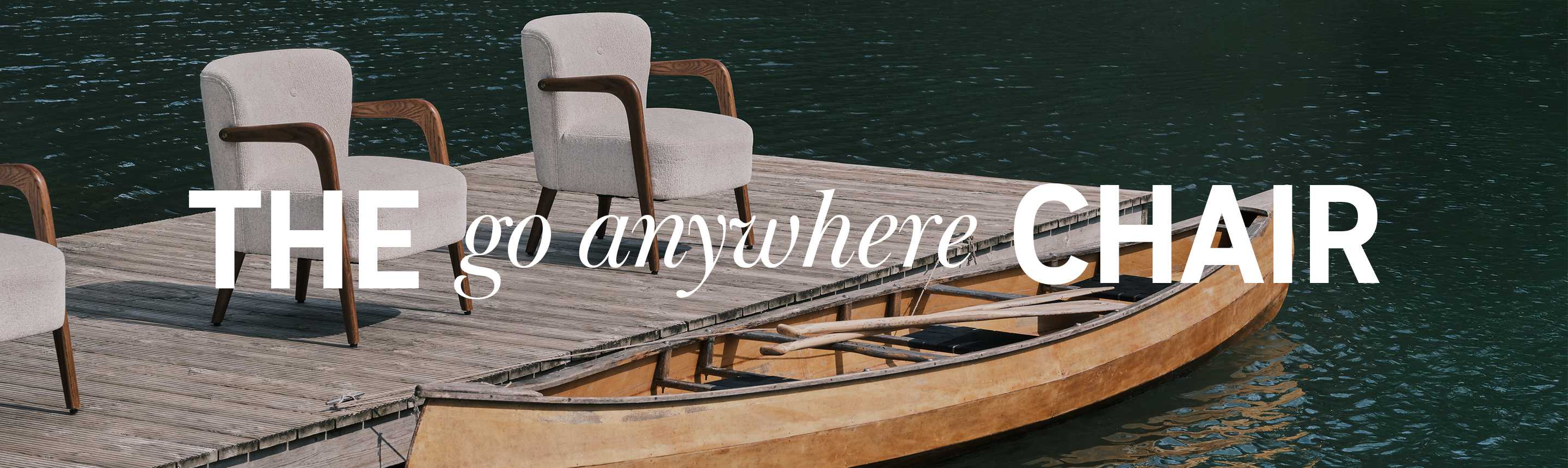 2 Habitat armchairs placed on a deck by a lakeside.