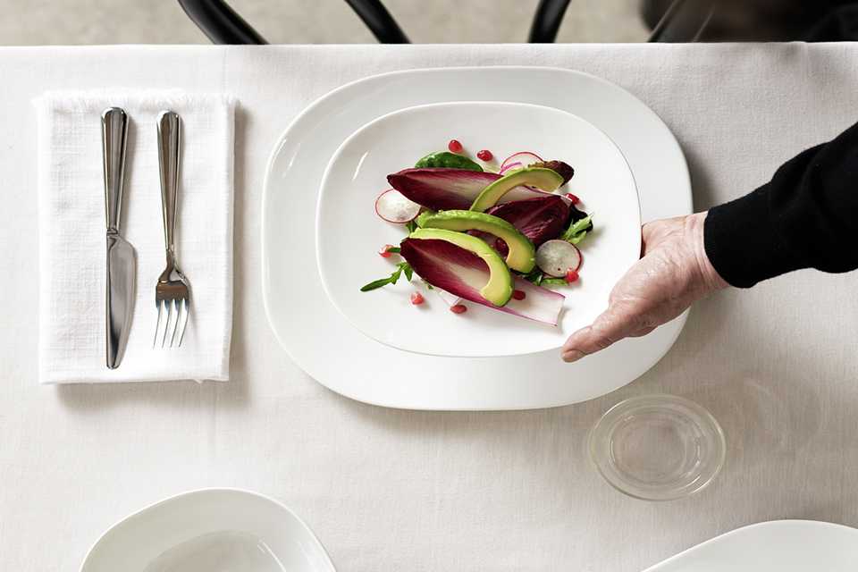 A table set with a white Sebastian Conran 12 piece porcelain dinner set.