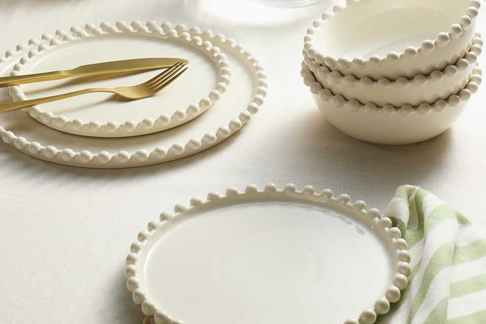 A table set with a Habitat Bobbin 12 piece stoneware dinner set in cream.
