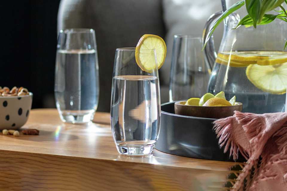 Habitat Portofino set of 4 Hi ball glasses on a table with water and some lemon next to a jug.