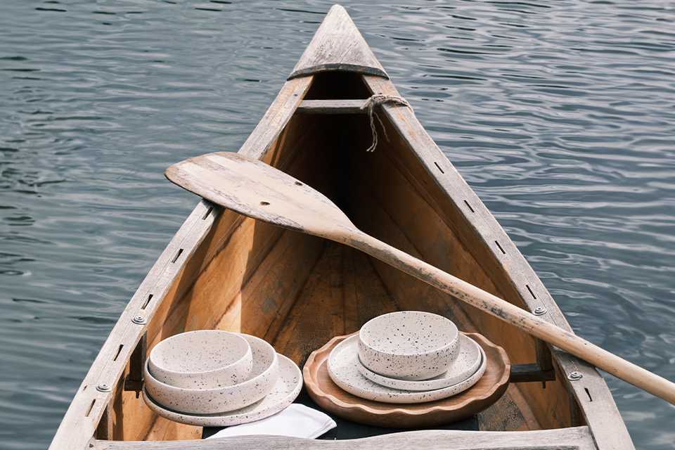 A Habitat dinneware set in white colour placed inside a boat.