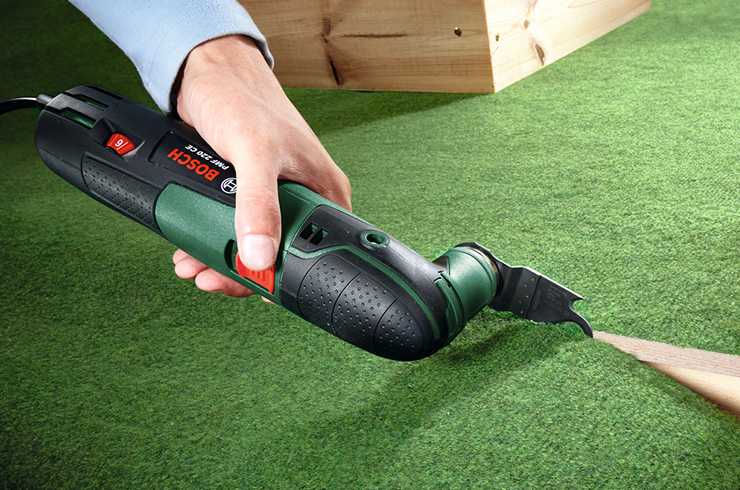Bosch hand multi tool being used to cut through carpet
