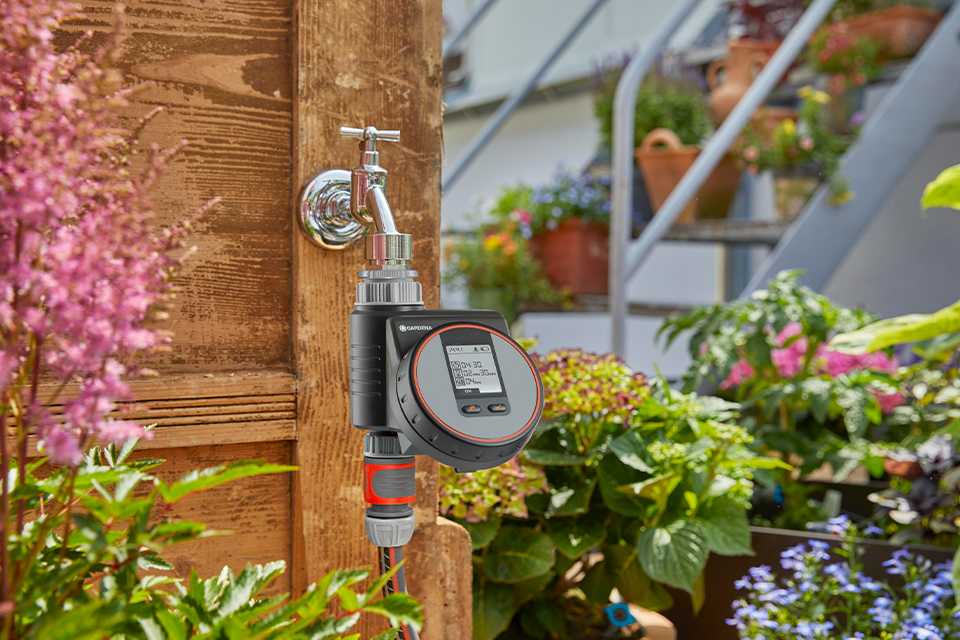 A user pressing the buttons on a Gardena Water Control Flex.