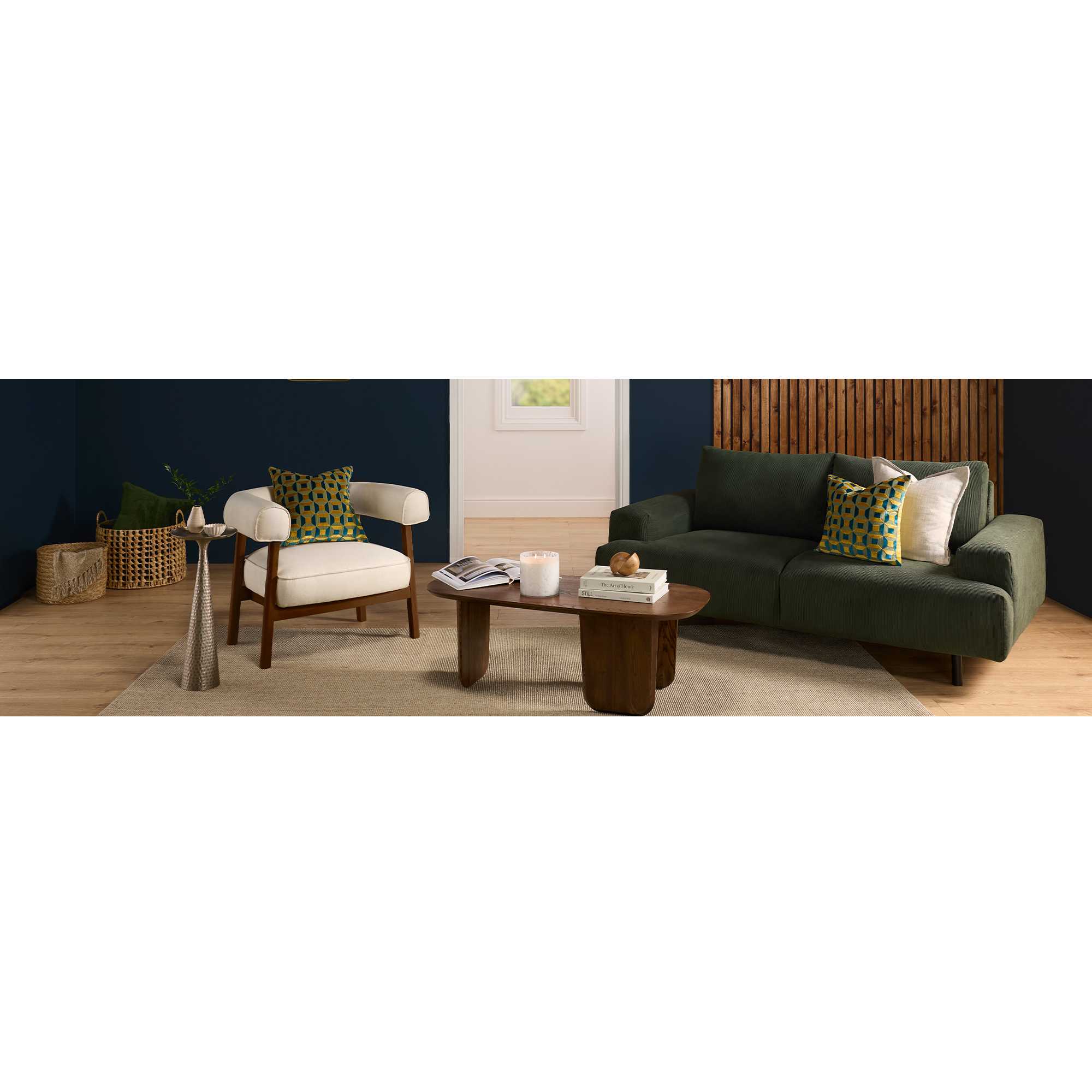 Blue living room with green sofa and wooden furniture with gold accessories.
