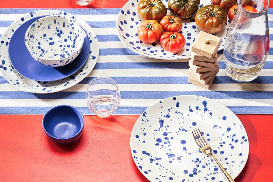 Habitat 60 Jackson Stoneware Platter in blue colour placed outdoors on a red dining table and blue stripped runner.