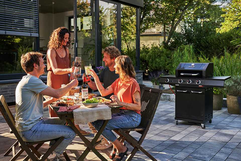 Outdoor BBQ with friends in a garden.