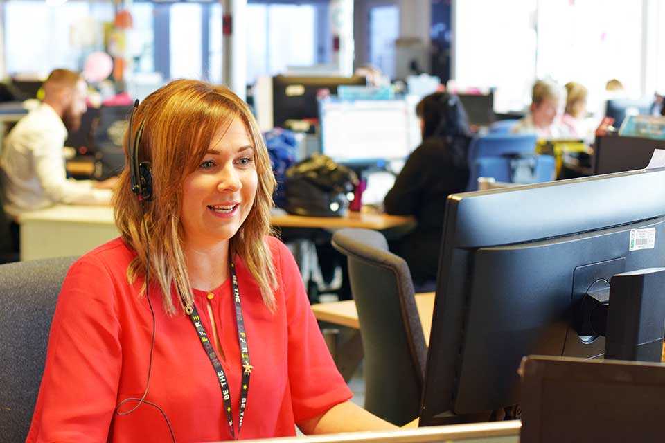 A customer care executive talking on phone with a customer.
