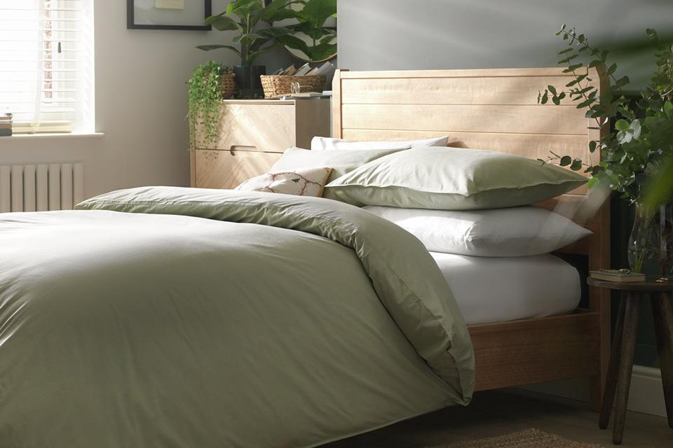 Image of a guest bedroom with a patterned pillow and duvet set.