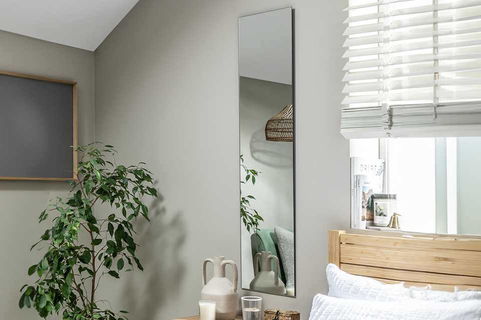 Bedroom mirror hanging on wall.