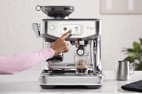A Sage coffee machine pouring coffee in a cup.