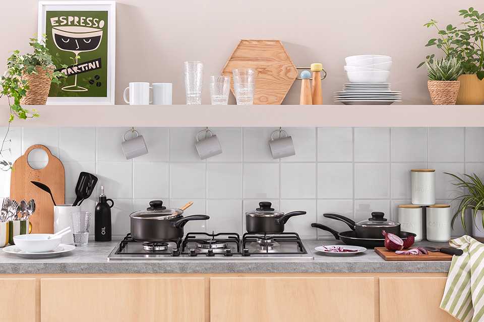 Kitchen set up with pots pans and a variety of accessories