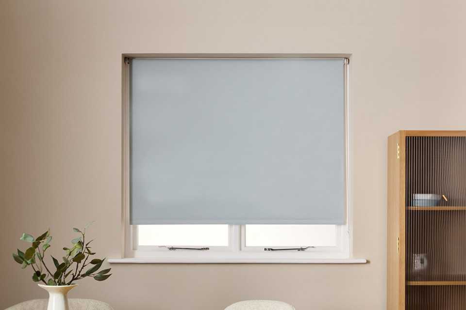 Blue roller blind fitted into a window