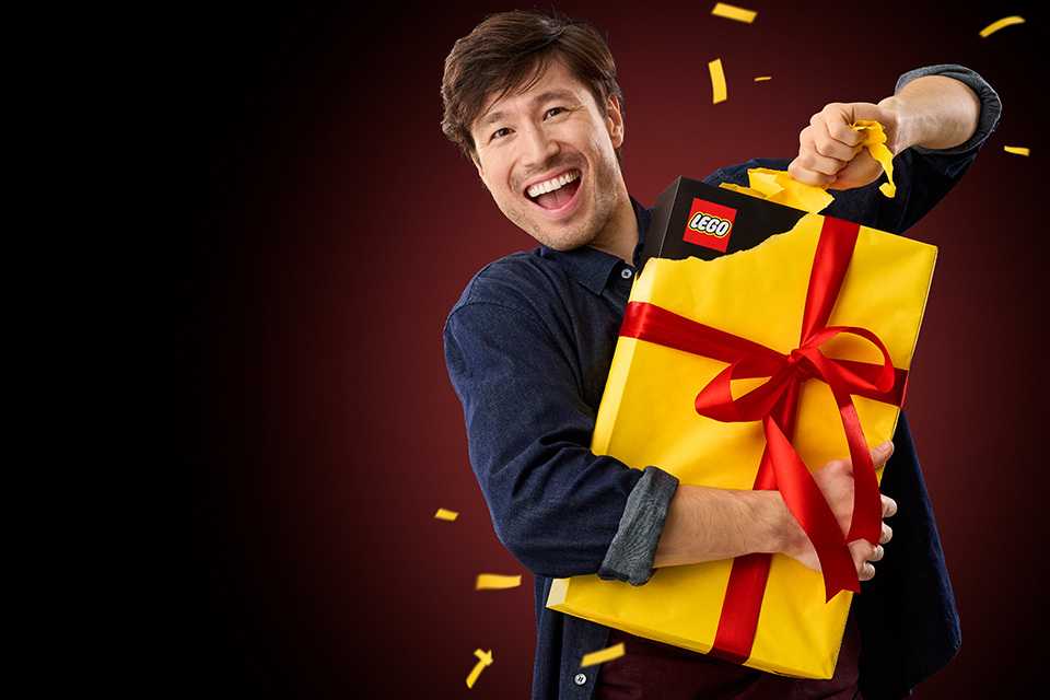 Man opening a LEGO® gift.