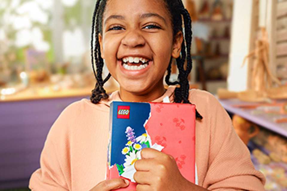 Girl opening a LEGO® Botanicals gift.