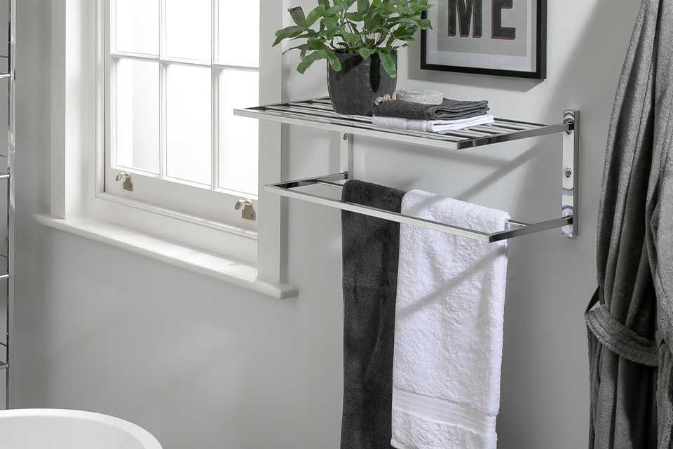 A steel towel holder wallmounted in a bathroom.
