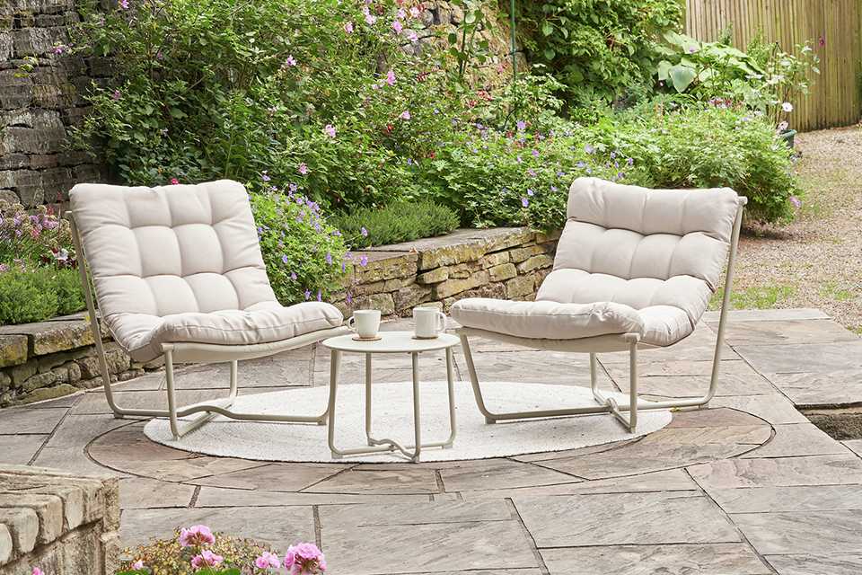 A Pacific Clermont set of 2 outdoor lounging chairs placed outdoors.