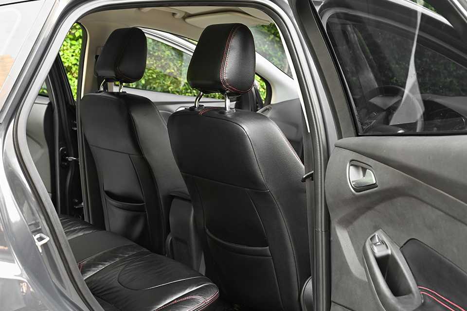 Black seat covers on all the seats of a car.