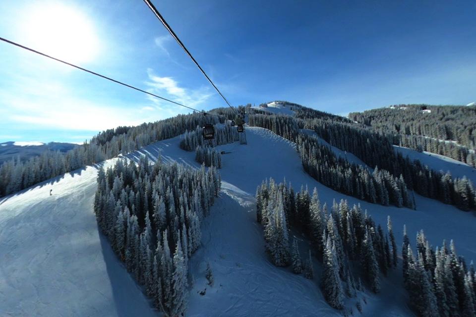 A snowy mountain landscape is captured from above.