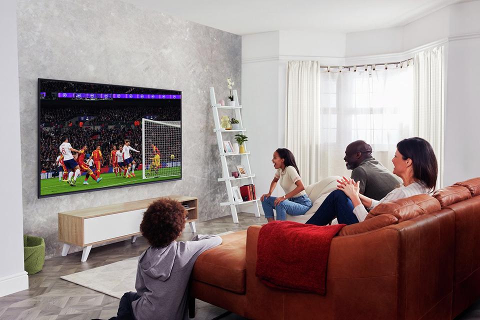 Family watching football in the lounge.