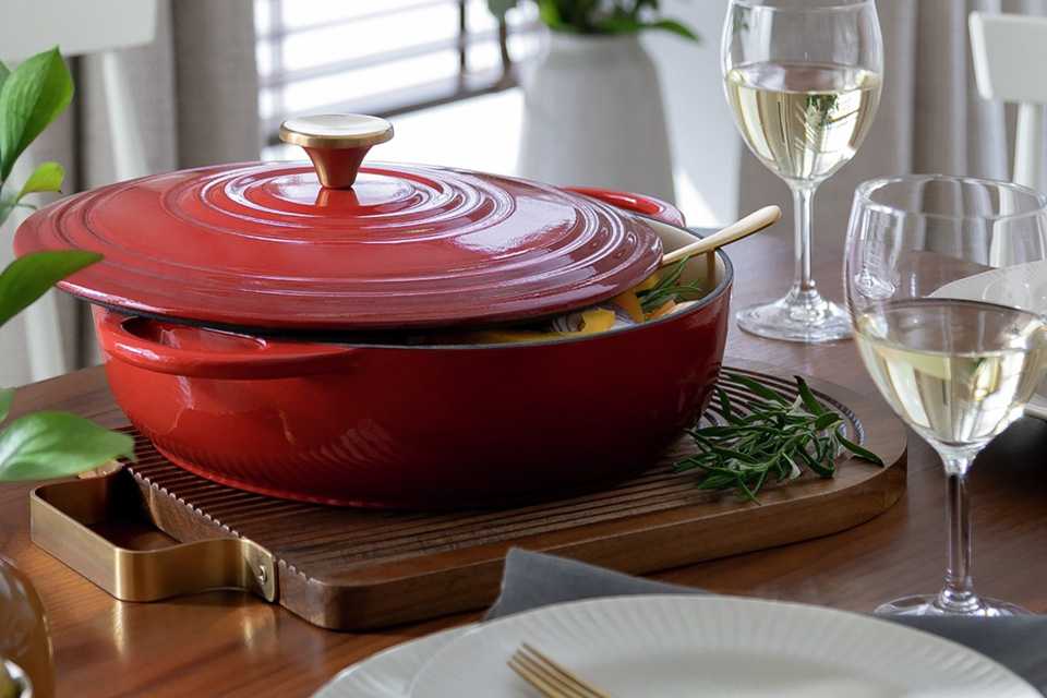 Habitat 4 Litre Cast Iron Shallow Casserole Dish placed on a wooden dining table.