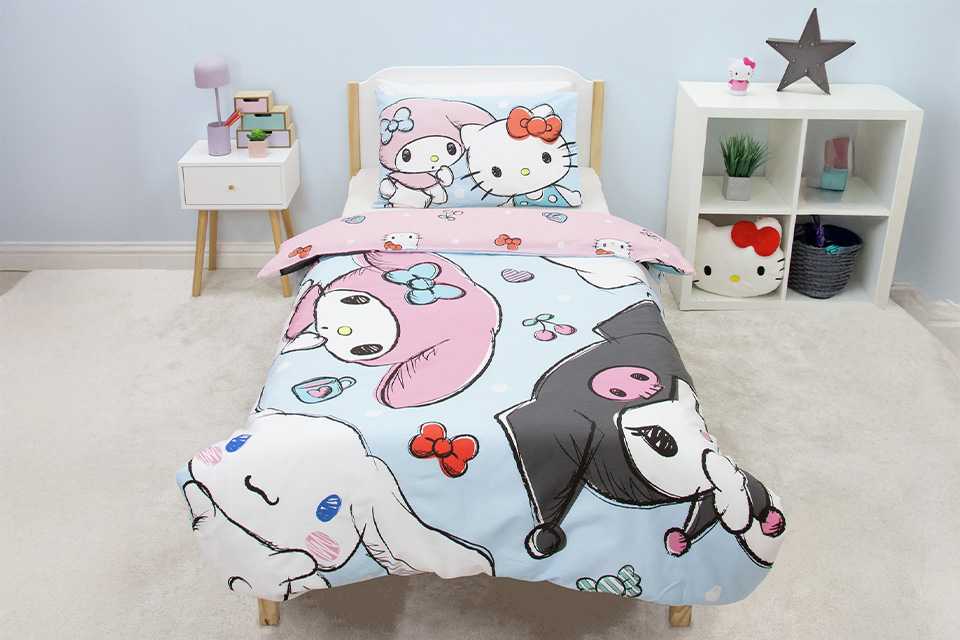A bed made with a Hello Kitty and Friends panel pink single bedding set.