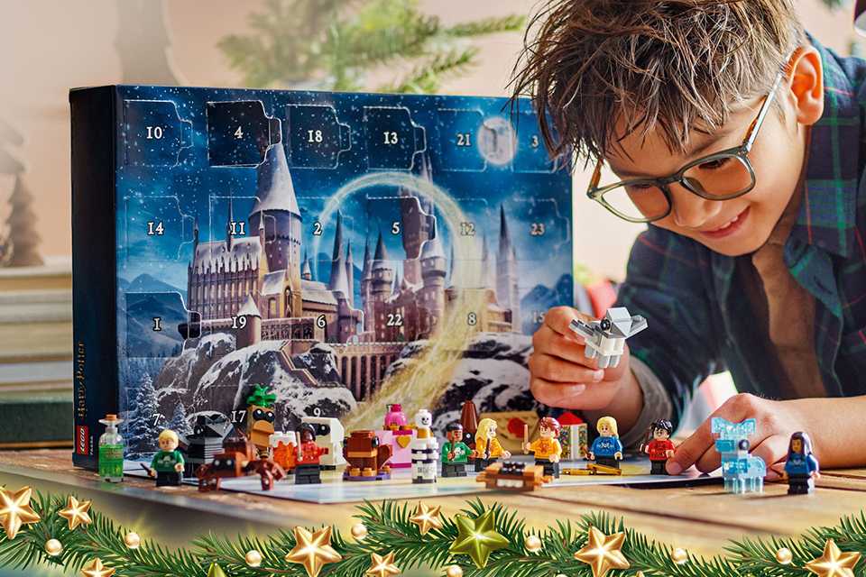 A boy playing with LEGO Harry Potter Advent Calendar 2025 Toy 76456.
