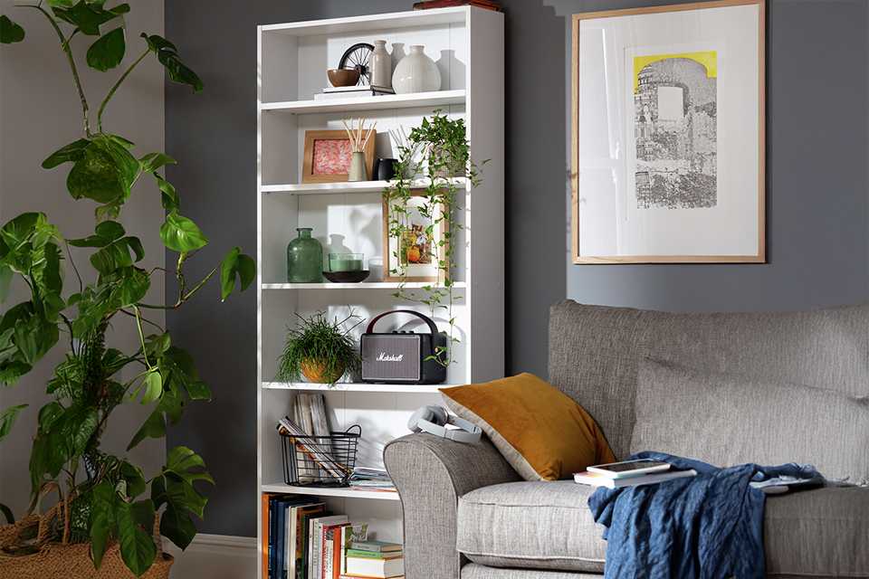 An Argos Home white bookcase in a living room.
