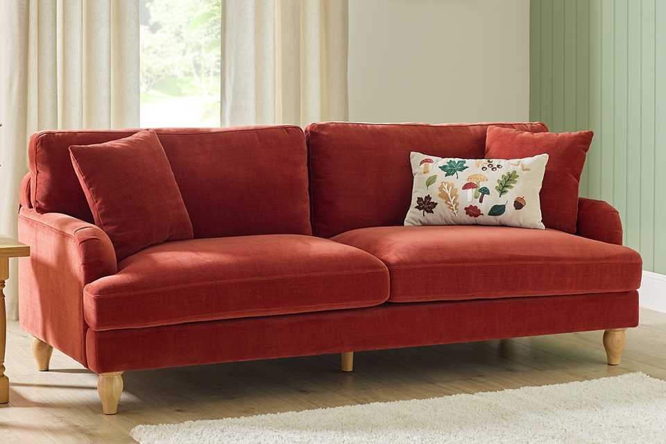 A velvet sofa in a living room.