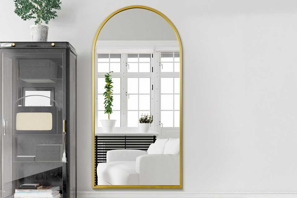 A MirrorOutlet Arcus Gold Metal Arch Wall Mirror.