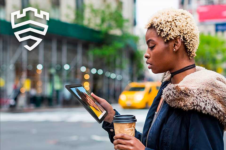 A lady using a tablet on the go.