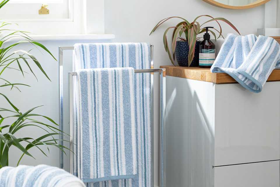 White and blue striped towels in bathroom.