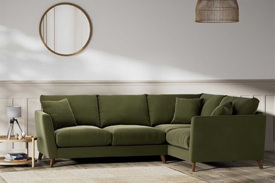 Green corner sofa in velvet.