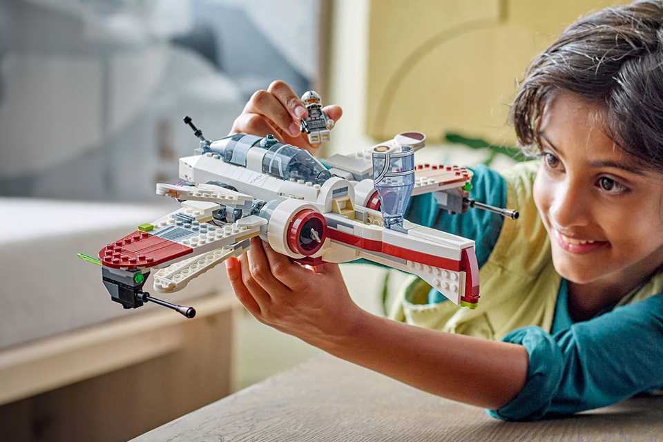 A boy playing with a LEGO® SMART Play™ set.